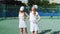 4K. Two girls warm up on the tennis court