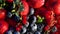 4k. Various colourful berries in glass blow rotation on black background, strawberry, raspberry, blackberry, blueberry, healthy fo