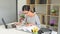 4k video of asian learning girl with reading a book or report data sheet with papers for study sitting by wooden table, Education