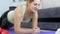 4k video of beautiful smiling young woman lying on fitness mat and using digital tablet. Girl watching fitness lessons