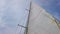 4K video bottom view of sail on yacht in Italy. The sail is large and white. The wind blows and the yacht floats in the