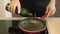 4K video of a caucasian man pouring extra virgin olive oil into a frying pan