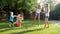 4k video of cheeruful laughing children with parent splashing water over each other from water guns and garden hose at