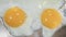 4K Video close up cooking 2 fried sunny side up eggs in silver metal pan