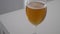 4K video of a cold beer in a glass holding it