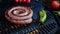 4K video cooking on grill sausage, twisted spiral, slow motion closeup, outdoors