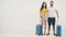 4k video of couple standing with blue suitcases over white background.