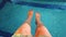 4K video of female beautiful legs in water.