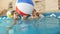 4k video of happy mother with child playing in indoor swimming pool with inflatable colorful beach ball