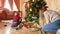 4k video of happy smiling family building toy railroad under Christmas tree in living room. Child receiving gifts and