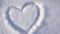 4K video, a heart drawn on the snow in the park. Valentine`s Day, slow camera zoom