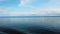 4K video of Lake Constance, Bodensee. Yachts sail on the lake. The water is crystal blue and behind it stands high snowy