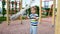 4k video of little smiling boy boy playing with rope for climbing on playground at park