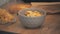 4k video of male hand putting a bowl of cornflakes on table.