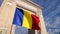 4K Video with the National flag of Romania winding in front of the Arch of Triumph