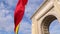 4K Video with the National flag of Romania winding in front of the Arch of Triumph