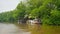 4k video of old motorboat moored at wooden pier on the river at tropical jungle rainforest