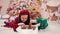 4k video portrait of two cute little children eating Christmas sweets. Craft chocolate handmade sweets in hands of kids