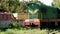 4k video of riding old diesel locomotive train near big metal scrapyard. Concept of transportation and metal recycling