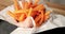 4k video slow motion stock footage french fries. rotating and close up chip fries on black plate and wooden table. party snack