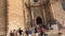 4K video of a vertical pan of the main facade of Valencia Cathedral while tourists are observing the church