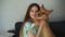 4k video welsh Corgi Pembroke dog kiss his girl owner at home. Lifestyle with domestic playful pet. Young woman hug