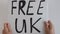 4k video of woman holding protest poster with words `Free UK`.