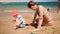 4k video of young mother with her child son playing with toy car on the sea beach. Family relaxing during summer beach