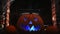 4k vidoe of pumpking changing colours on spooky fire place. wram flickering backlight