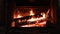 4K Warm cozy burning fire in a brick fireplace, close-up shot