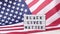 4k Waving American Flag Background. Lightbox with text BLACK LIVES MATTER Flag of the united states of America. July 4th