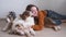 4k. Woman holding three beatiful Small merle Australian shepherd puppy dog