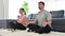 4K Young couple practicing yoga doing lotus pose and breathing exercises living room