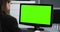 4K: A young secretary is working in her Office. The monitor is keyed in chroma green for compositing.