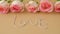 4k zoom in out Delicate pink rose on beige background. Word LOVE made of rope. Minimal trendy composition. Romantic