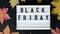 4k zoom in out Lightbox with text BLACK FRIDAY around autumn fall leaves, Sale shopping concept. Template Black friday