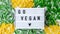 4k zoom in out Lightbox with text GO VEGAN frozen vegetables food of yellow corn, green beans. Harvest Food preservation