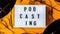 4k zoom in out Podcasting lettering and vinyl record album audio cassette tape on yellow background. Millenial. Blogger