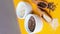 4k zoom in out vertical Wooden spoons with flax and sesame seeds lies in a white mortar on a yellow background. Healthy