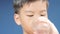 4k Zoom out of young Asian boy drinking water