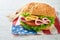 4th of July American Independence Day traditional picnic food American sandwich or Burger on white American flags symbols of USA