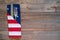 4th of July Rustic Picnic Table Place Setting with silverware and American Flag napkin with background of wood boards for copy spa