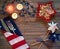 4th of July Table Setting with Rustic Wood Background providing copy space, and red white and blue decorations.  It`s a horizonta