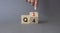 From 4th Quarter to 1st symbol. Businessman hand points at Turned wooden cube with words 4th Quarter and 1st Quarter. Beautiful