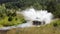 A 4wd car overcomes a water obstacle at high speed surrounded by spray