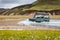 4WD car wades river in Landmannalaugar in Iceland