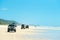 4wd vehicles at Rainbow Beach with coloured sand dunes, QLD, Australia