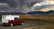 4x4 Camper van on view point plateau, endless lonely dry arid icelandic landscape, weather change with dark strom clouds - central