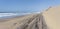 4x4 car on beach at foreshore between Atlantic waves and dunes of Naukluft desert, Walvis Bay, Namibia