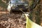 4x4 off-road car pulls itself out of the trap with a winch by snagging on a tree